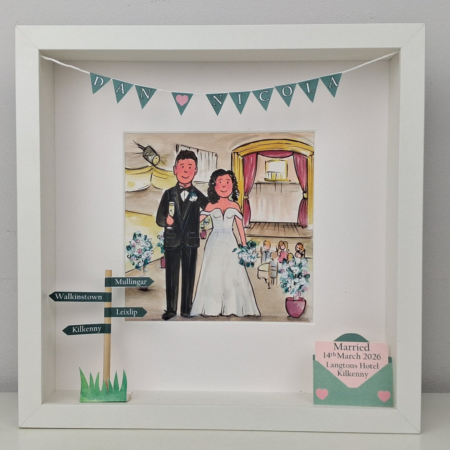 Framed artwork of a bride and groom with decorative elements on a white background