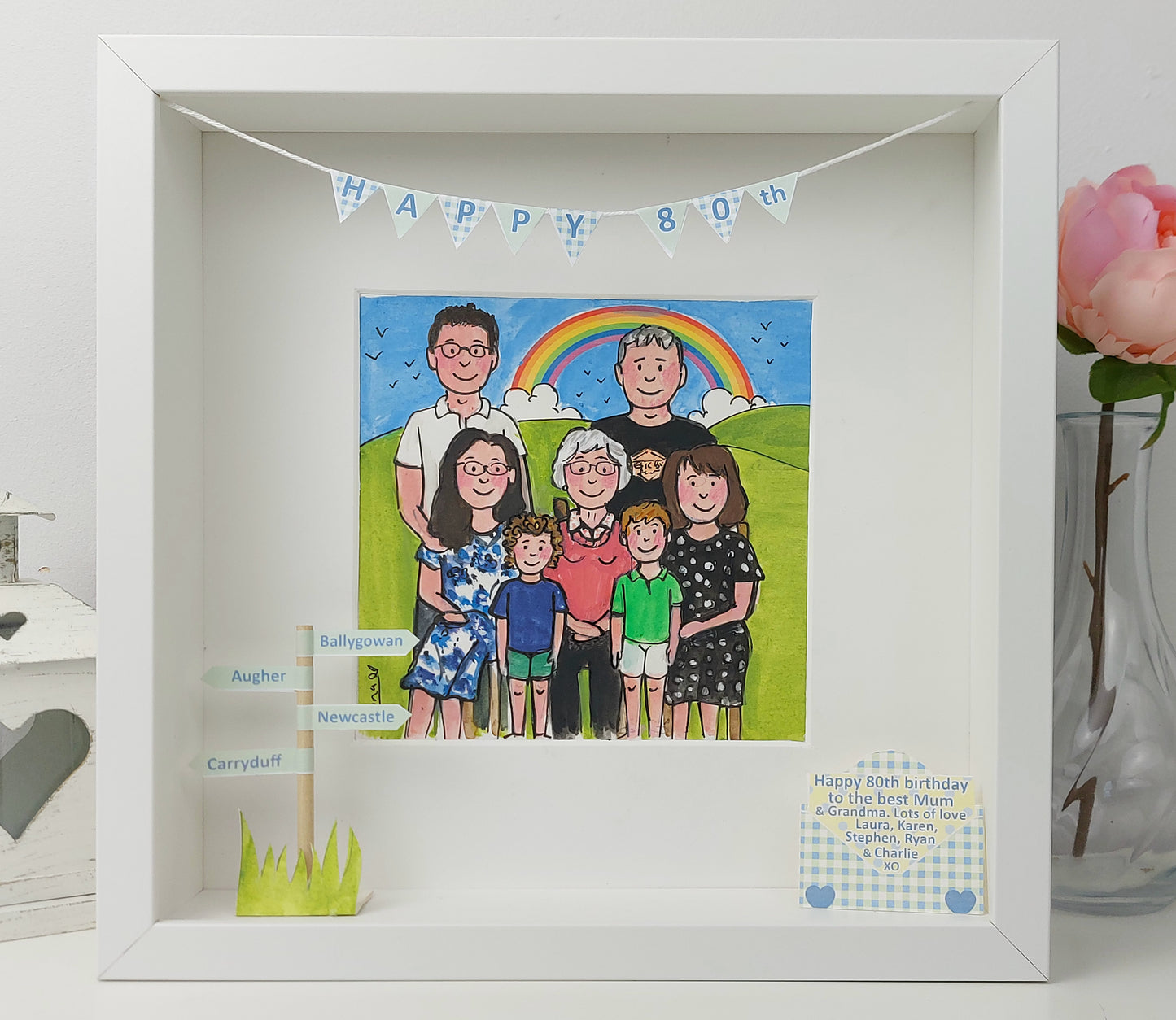 Framed illustration of a family with a rainbow and 'Happy 80th' banner.