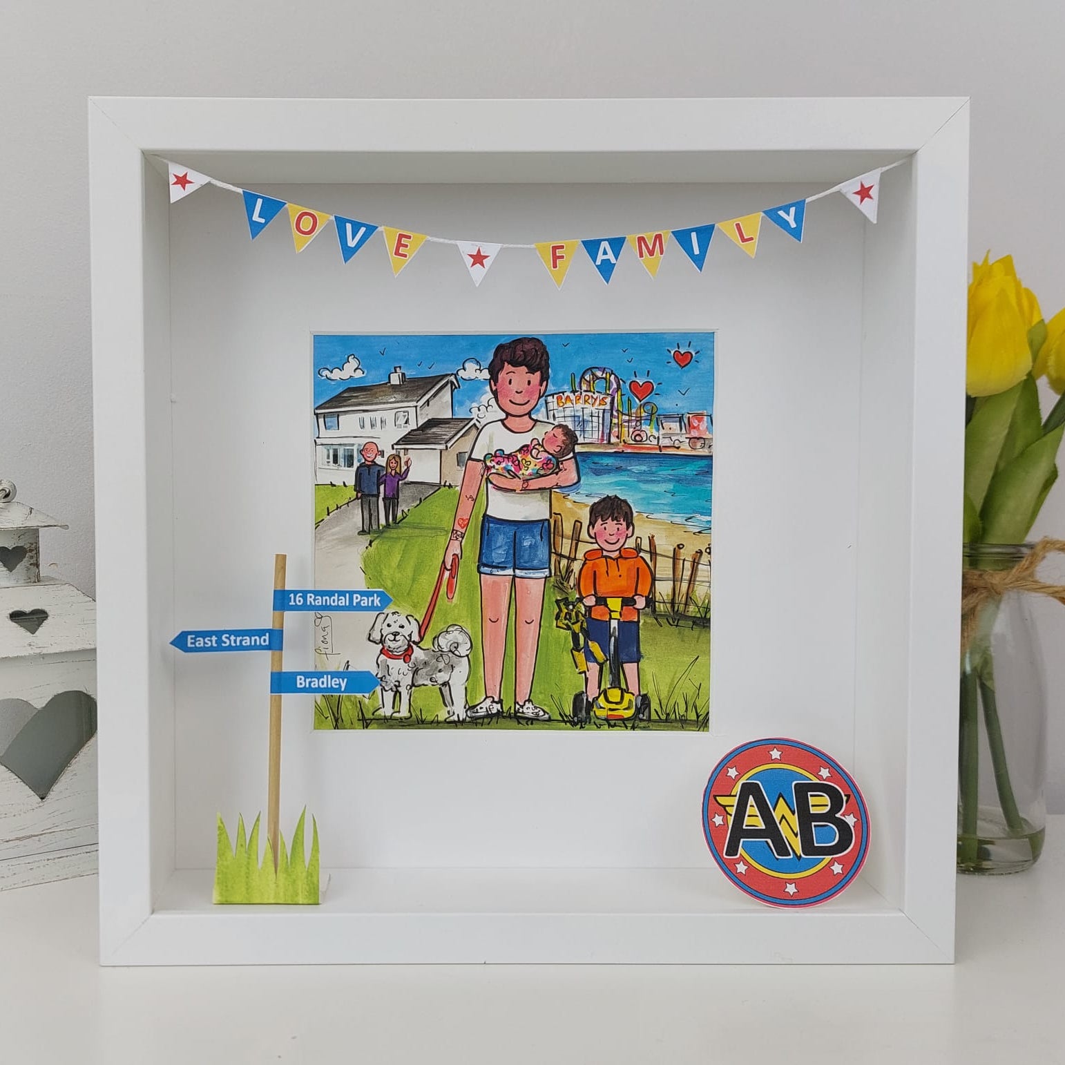 A colorful illustration of an aunt with her two children, displayed in a frame, with a 'Love Family' decoration on top, set against a white background with a blurred image of a beach in the background.