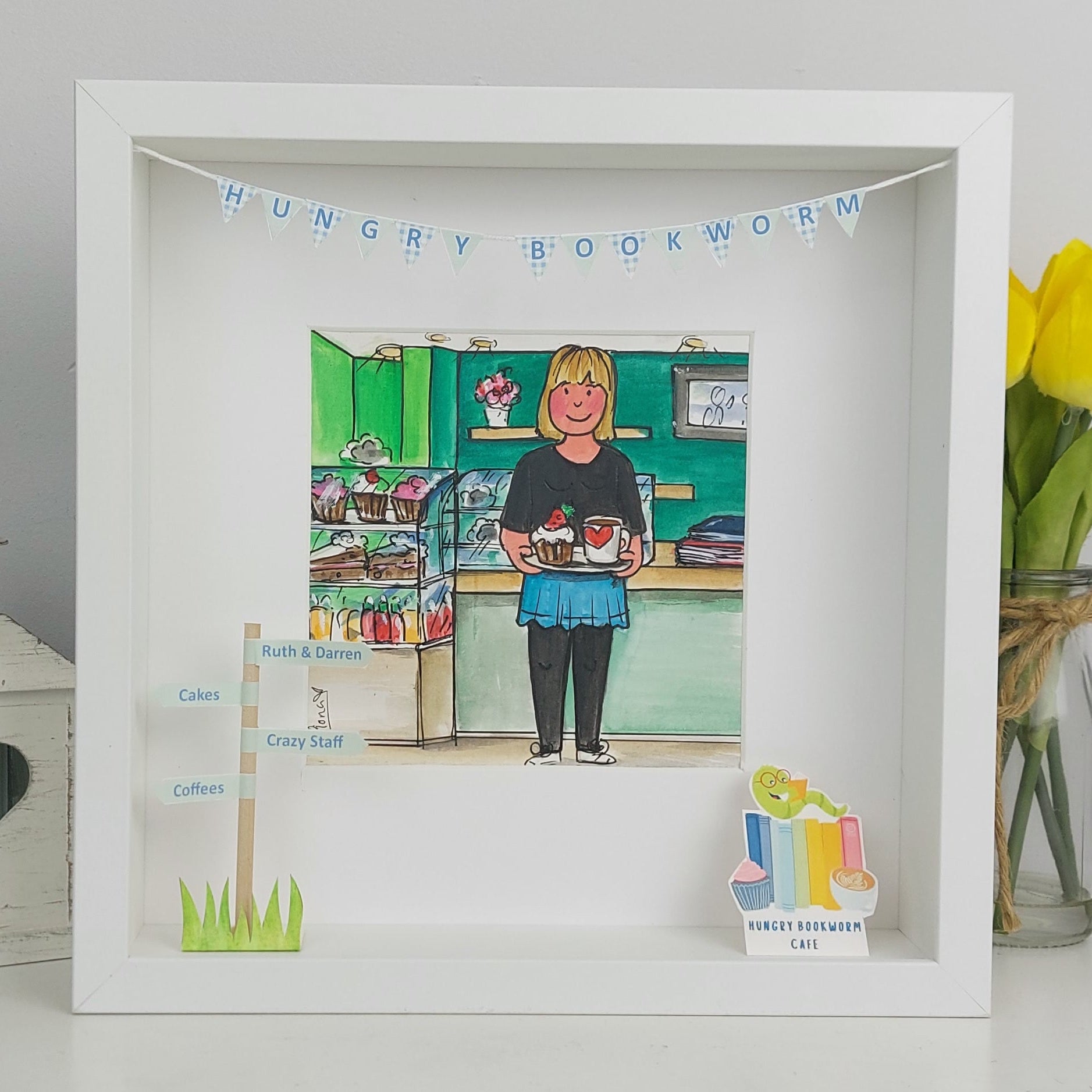 White shadow box with illustrations of a person in a bookshop and 'Hungry Bookworm' banner.