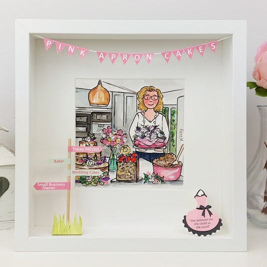 Framed illustration of a woman in a kitchen with 'Pink Apron Cakes' banner, surrounded by baking items.