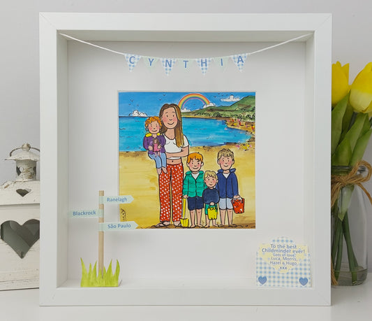 Framed childminder artwork of a woman with children on a beach, featuring a rainbow and ocean view.