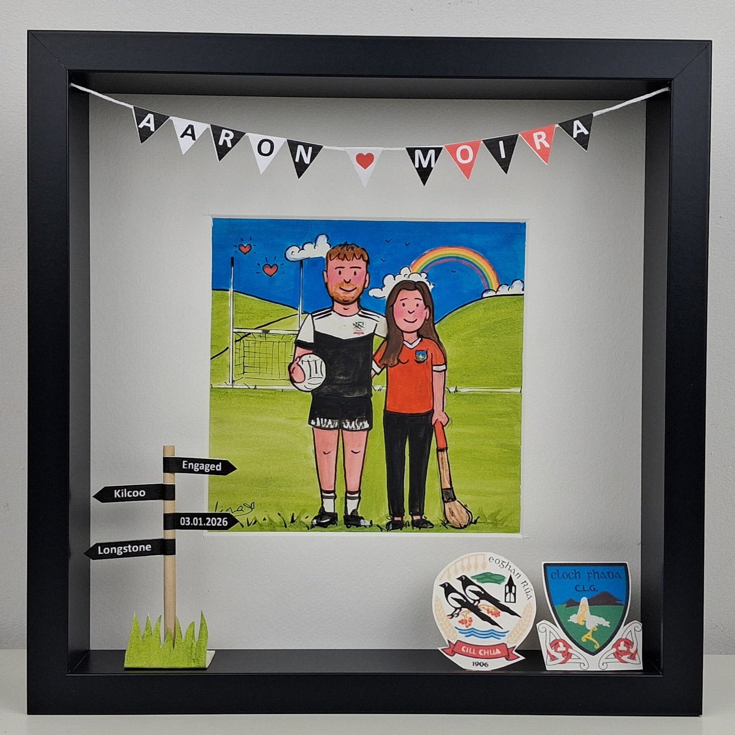 Framed artwork of a couple on a sports field with decorative elements.
