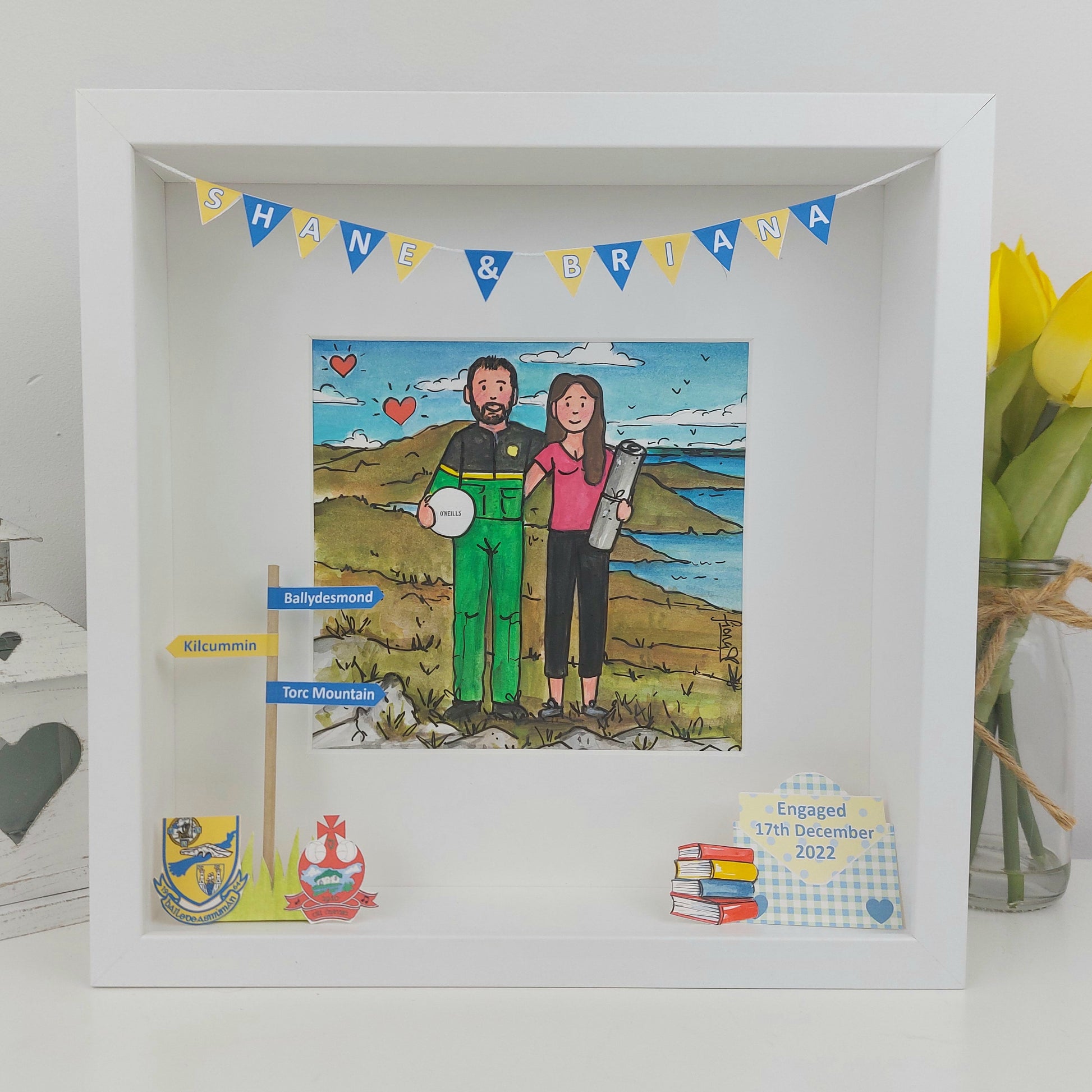 Framed artwork of a couple in a scenic setting with decorative elements.