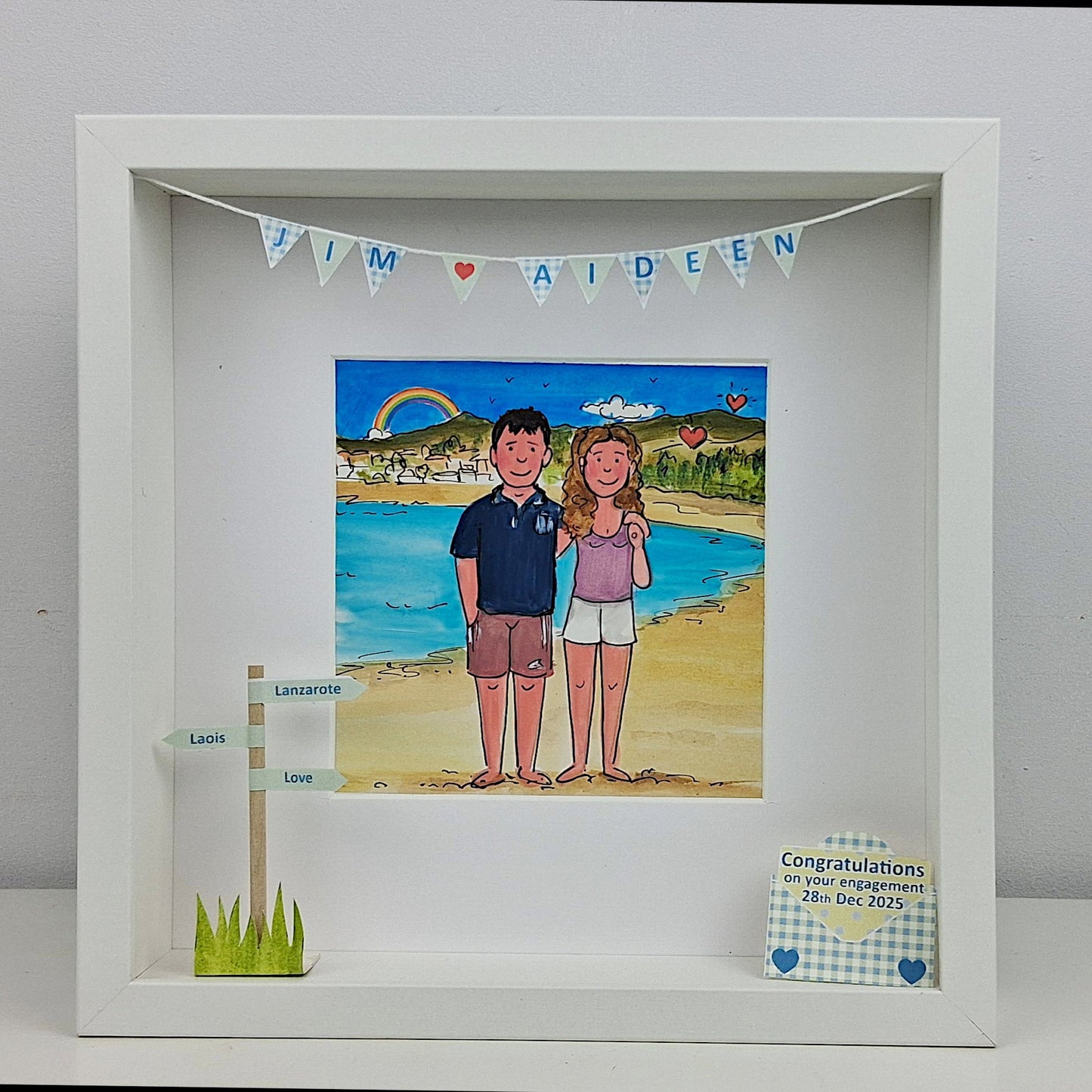 Framed artwork of a couple on a beach with personalized text