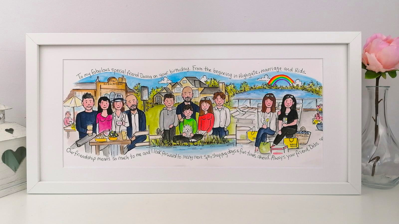 Framed illustration of a family at a picnic with personalized text on a white wall.