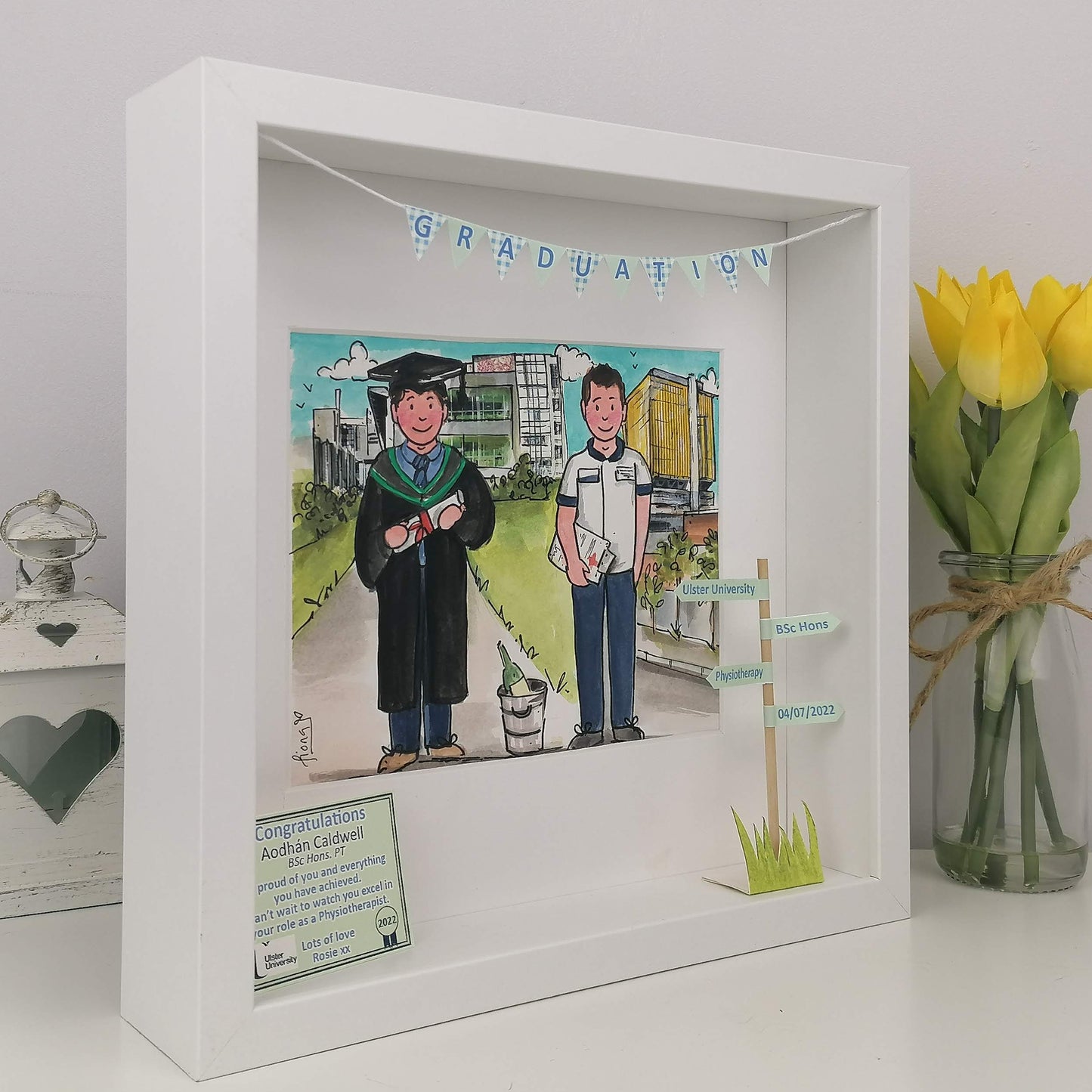 Graduation-themed shadow box with a photo of two people one in graduation attire, and 1 and a nurse doctor - with personalised congratulations