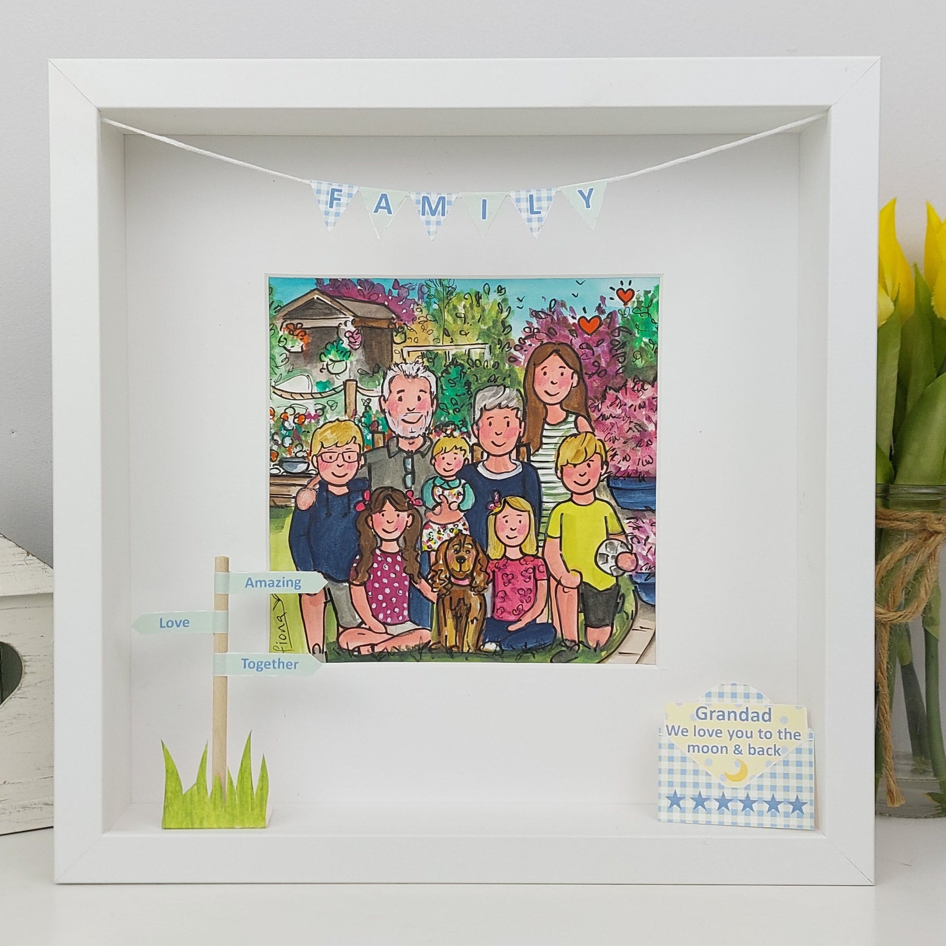 Framed illustration of a family with decorative elements on a white surface.