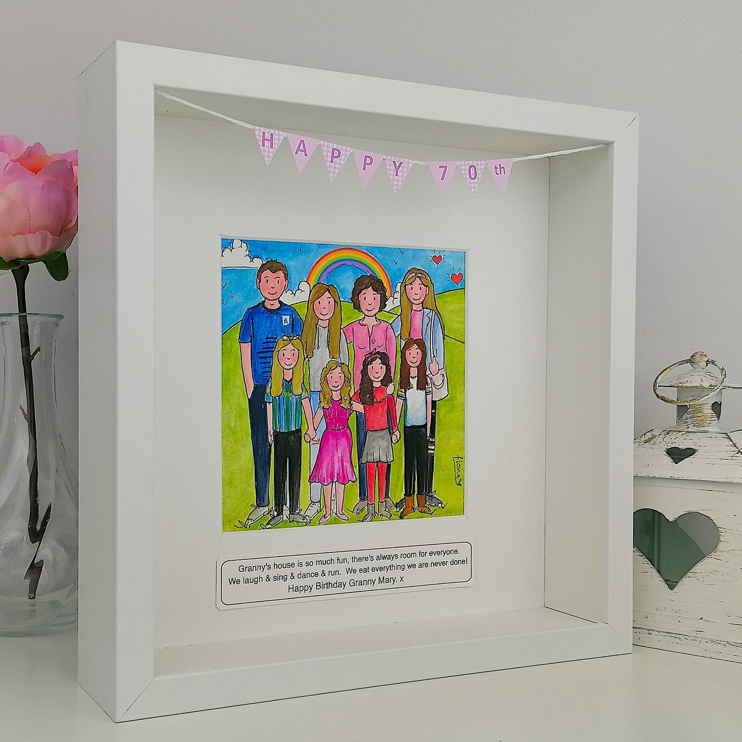 White framed artwork with a colorful illustration of a family and 'Happy 70' banner.