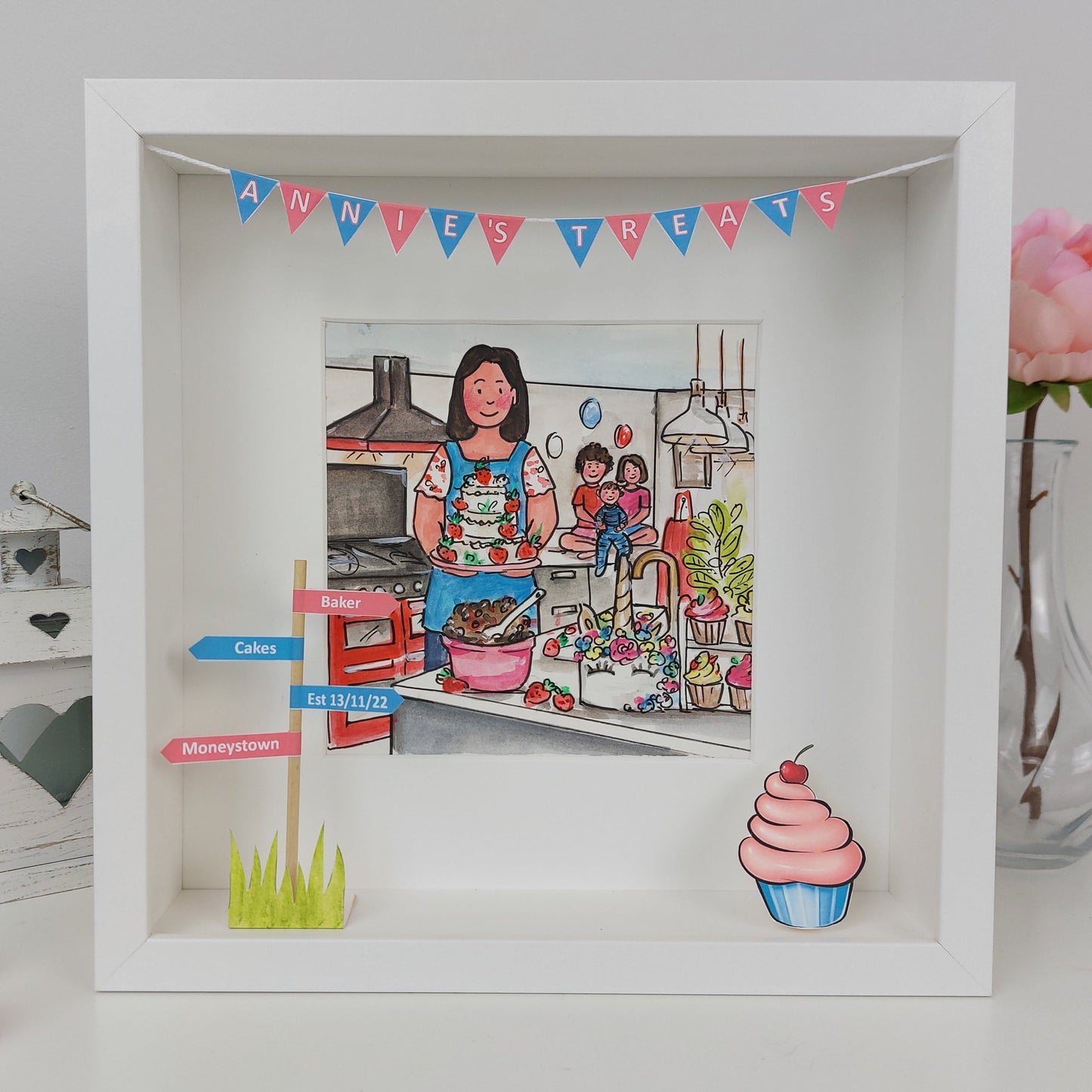 Framed illustration of a woman cooking with decorative elements and a pink flower in the background.