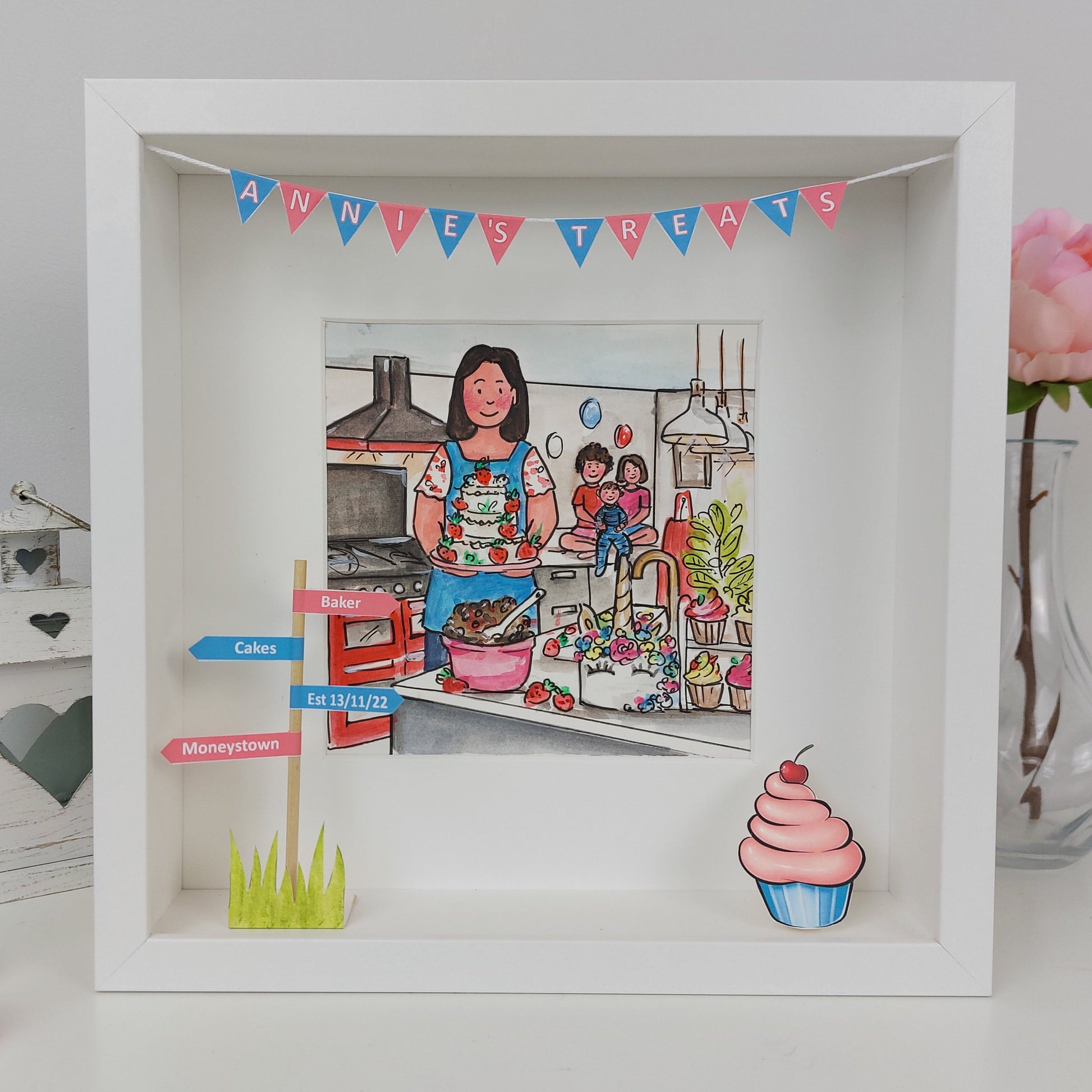 Framed illustration of a woman cooking with decorative elements and a pink flower in the background.