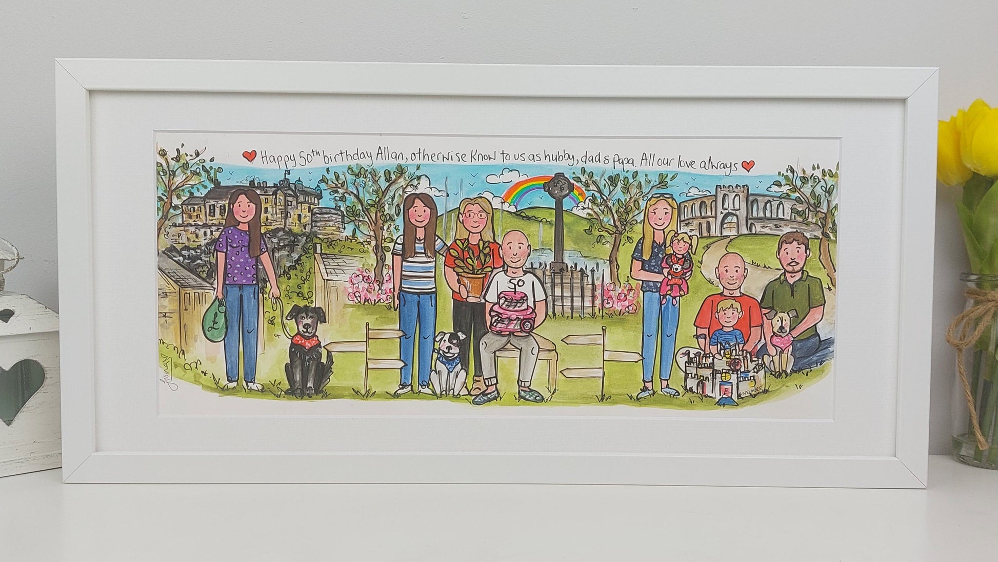 Framed illustration of a family with pets in a garden setting