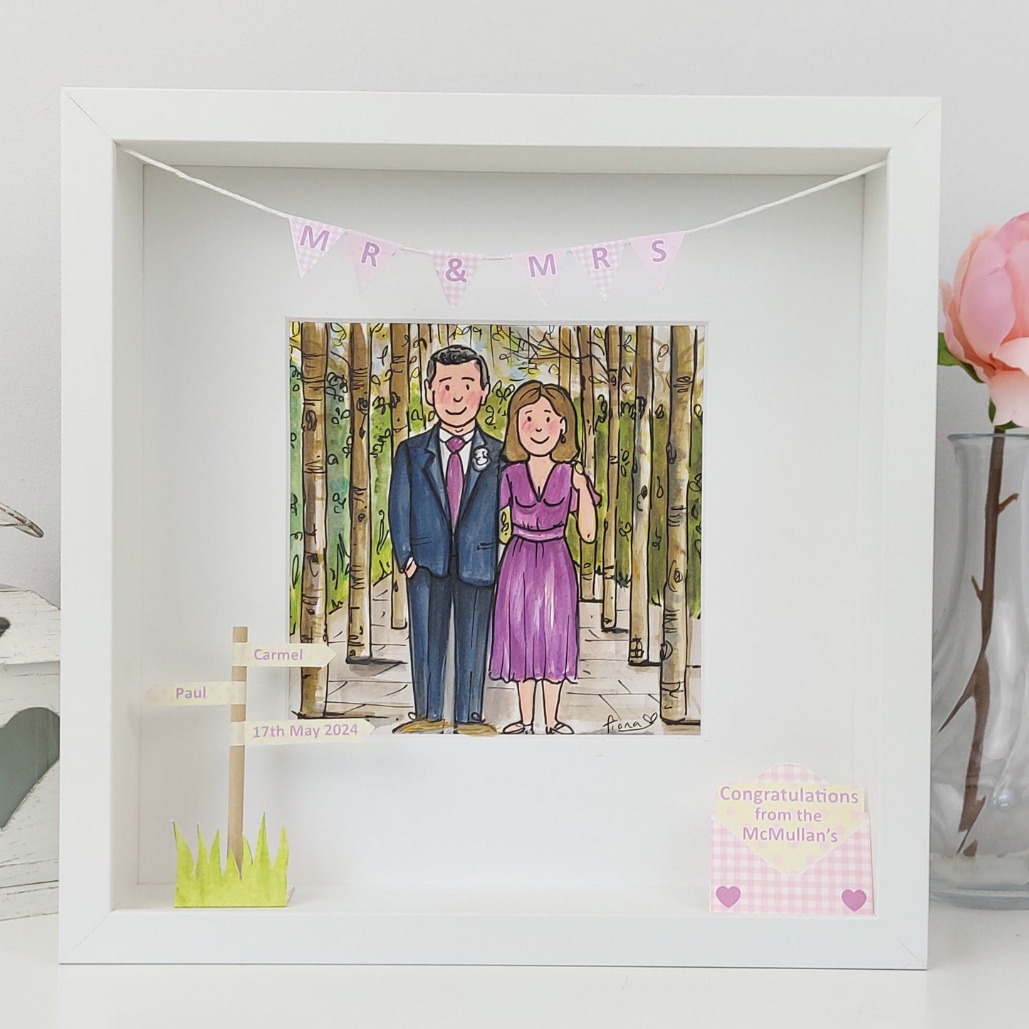 Framed illustration of a couple with 'MR & MRS' banner, surrounded by decorative elements.