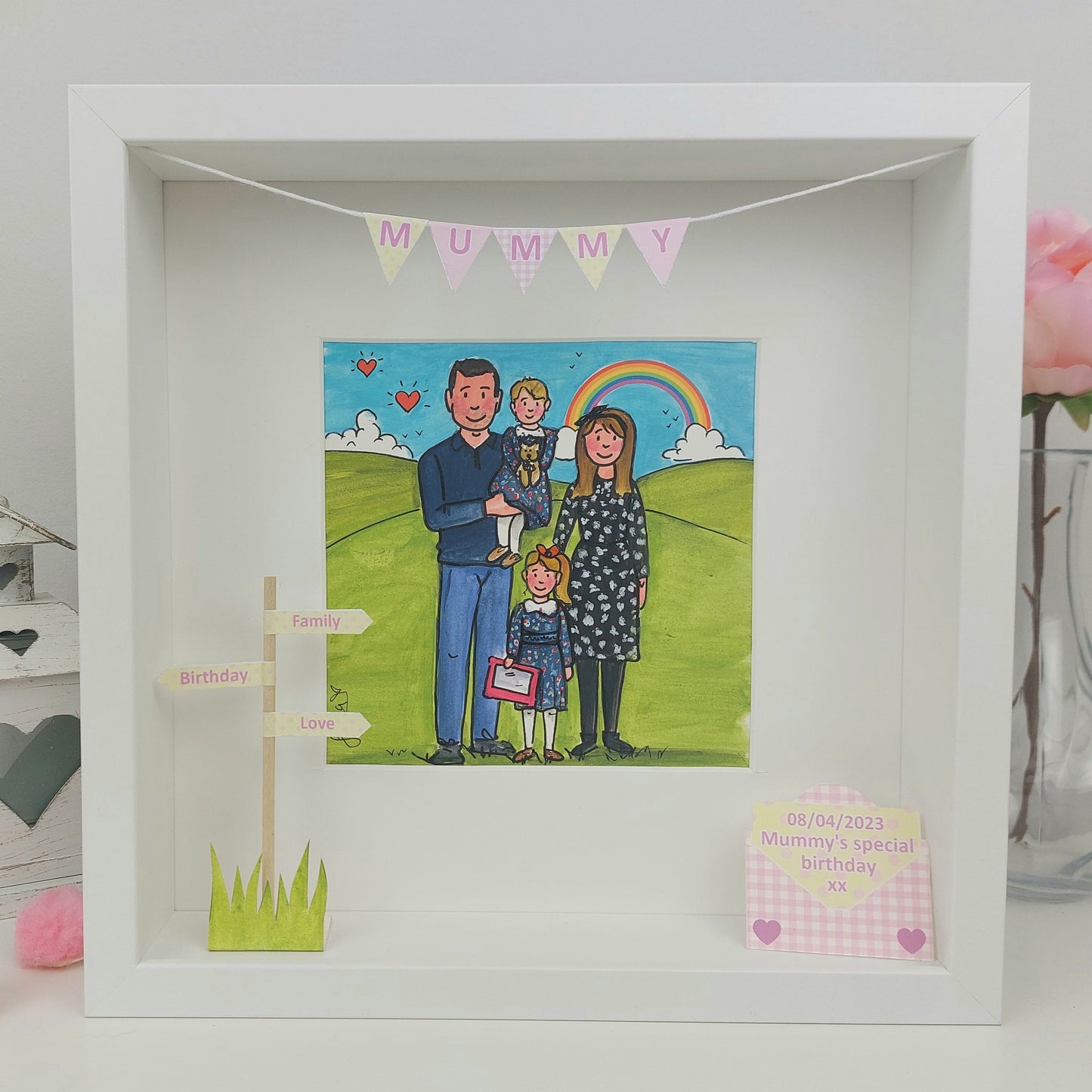 Framed illustration of a family with a rainbow and 'Mummy' banner. A cute colourful illustration with children and mum and dad