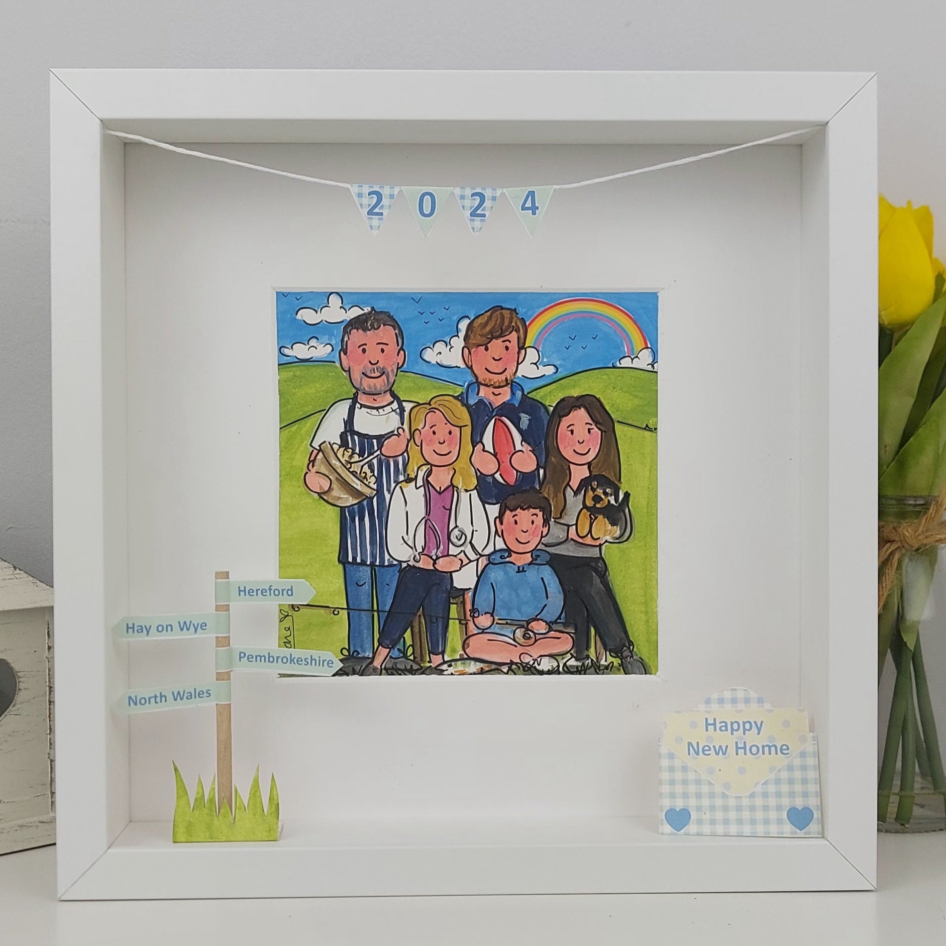 Framed artwork of a family with 'Happy New Home' message, 2024 text, and decorative elements.