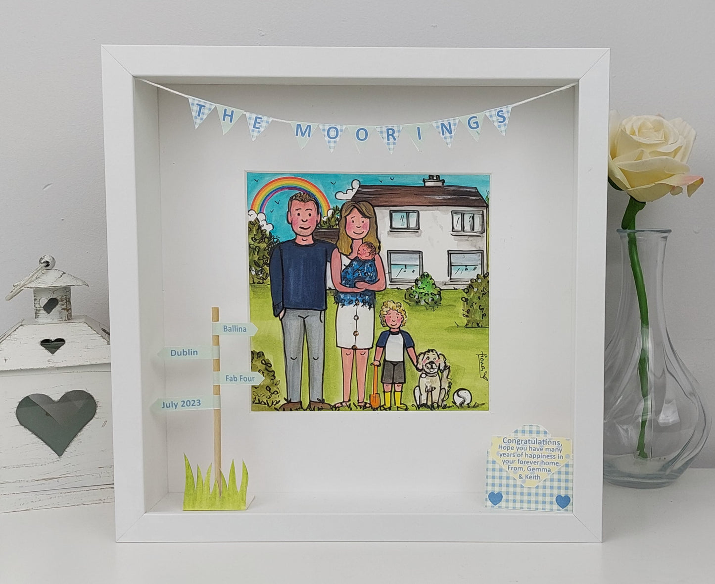 Framed artwork of a family with a rainbow and house illustration, New Home Congratulations - Cartoon Family, dog, hurling and New House Portrait