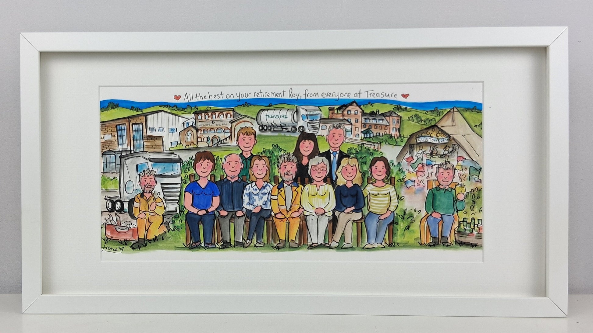 Framed artwork of a group of people in a village setting with a white frame.