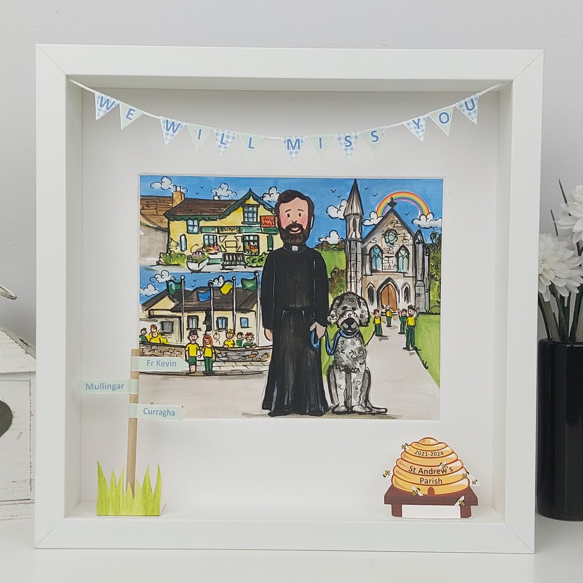 Framed artwork of a man with a dog and a church, with 'We Will Miss You' banner.