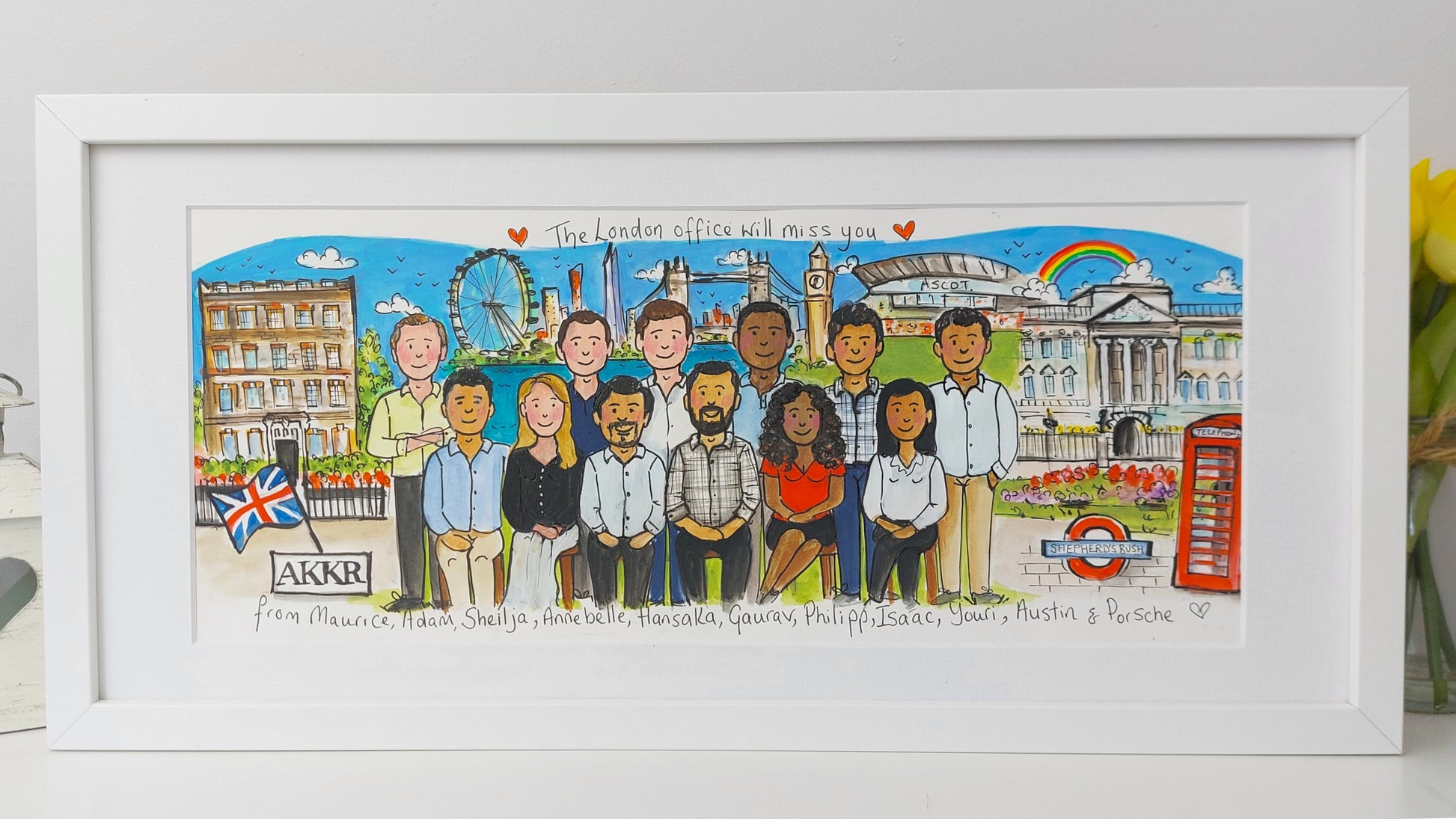 Framed artwork of a group of people in front of a London-themed background