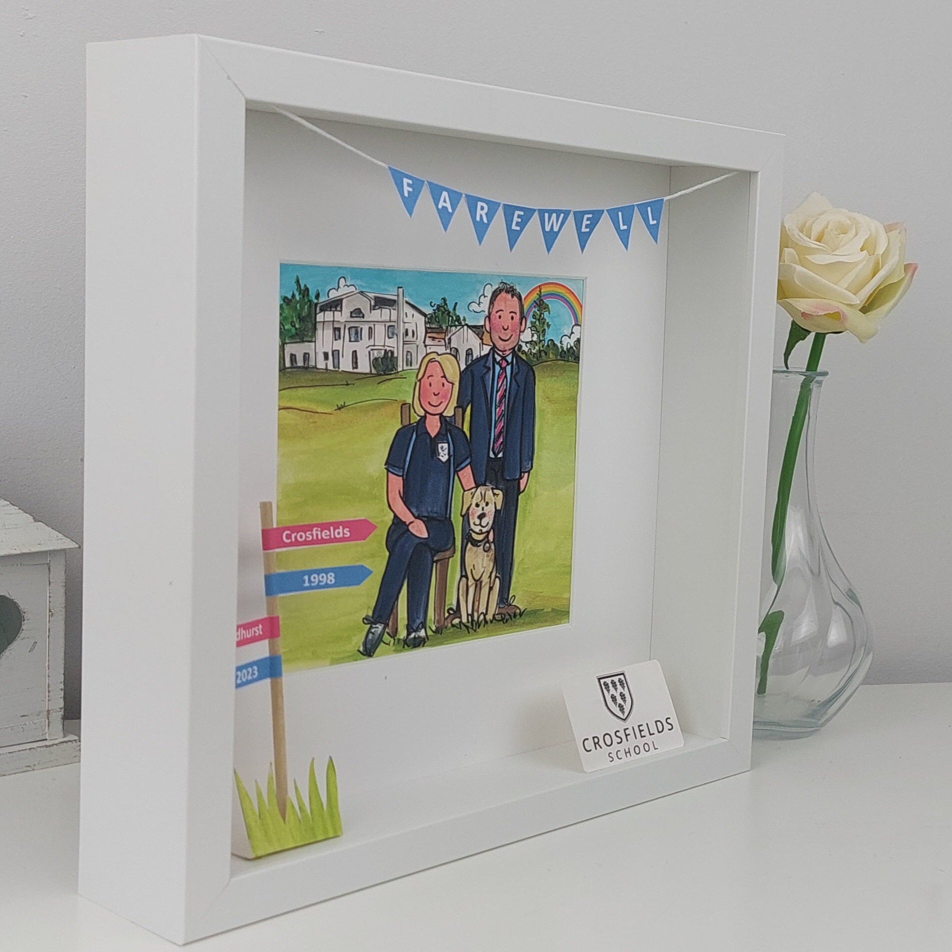 White framed artwork with caricatures of a couple and dog, set against a white background.