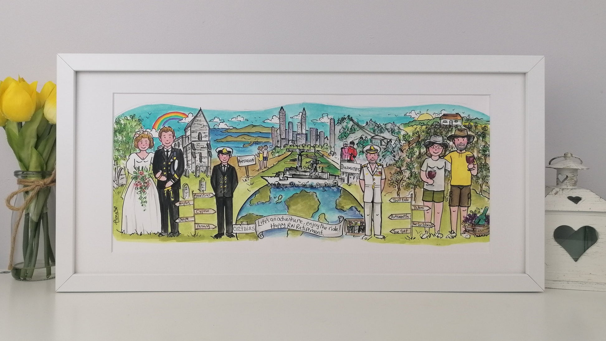 Framed artwork of a wedding scene with people and landmarks, a Navy ship on top of the world