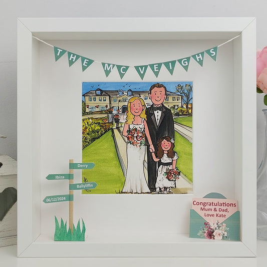 Framed artwork of a bride and groom with a child, personalized with text, on a light gray background.