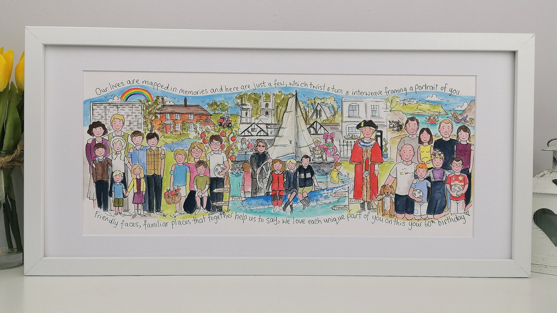 Framed artwork with colorful illustrations of people in various settings, displayed on a light gray wall.