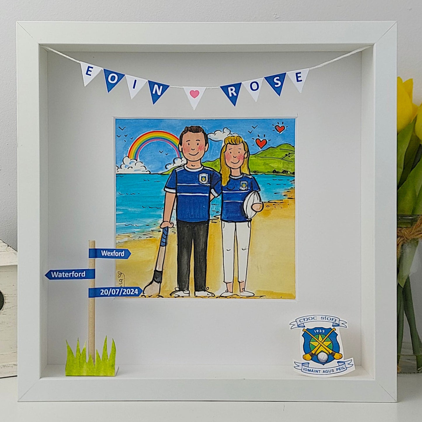 Framed artwork of a couple on a beach with personalized elements.