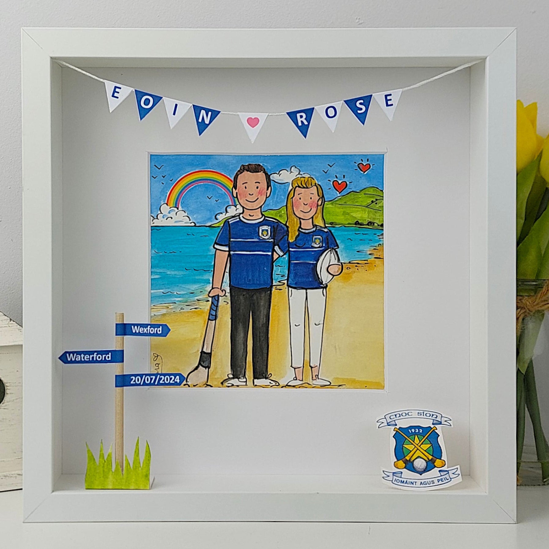 Framed artwork of a couple on a beach with personalized elements.