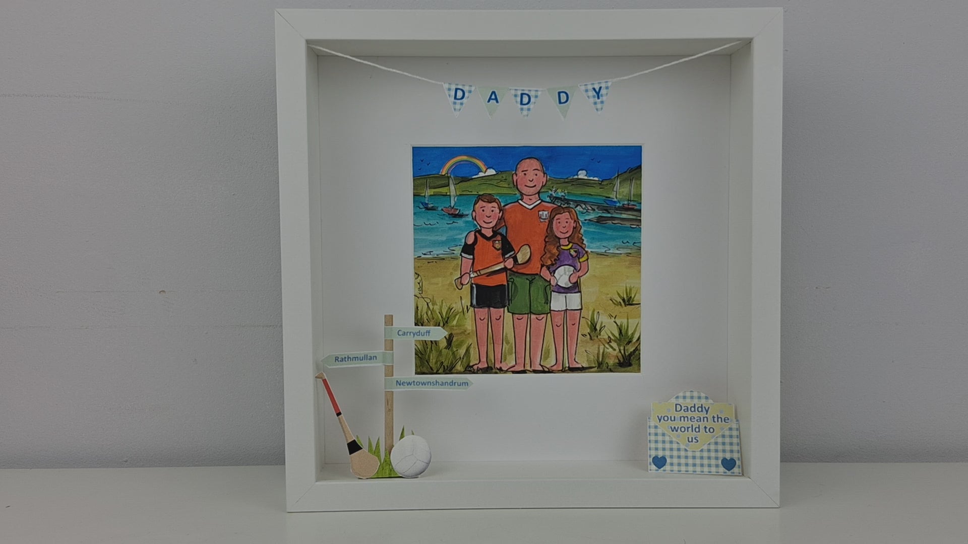 Daddy Daughter and Son on the beach with hurling stick and gaelic football illustration - In a white box frame with personalised 3d features