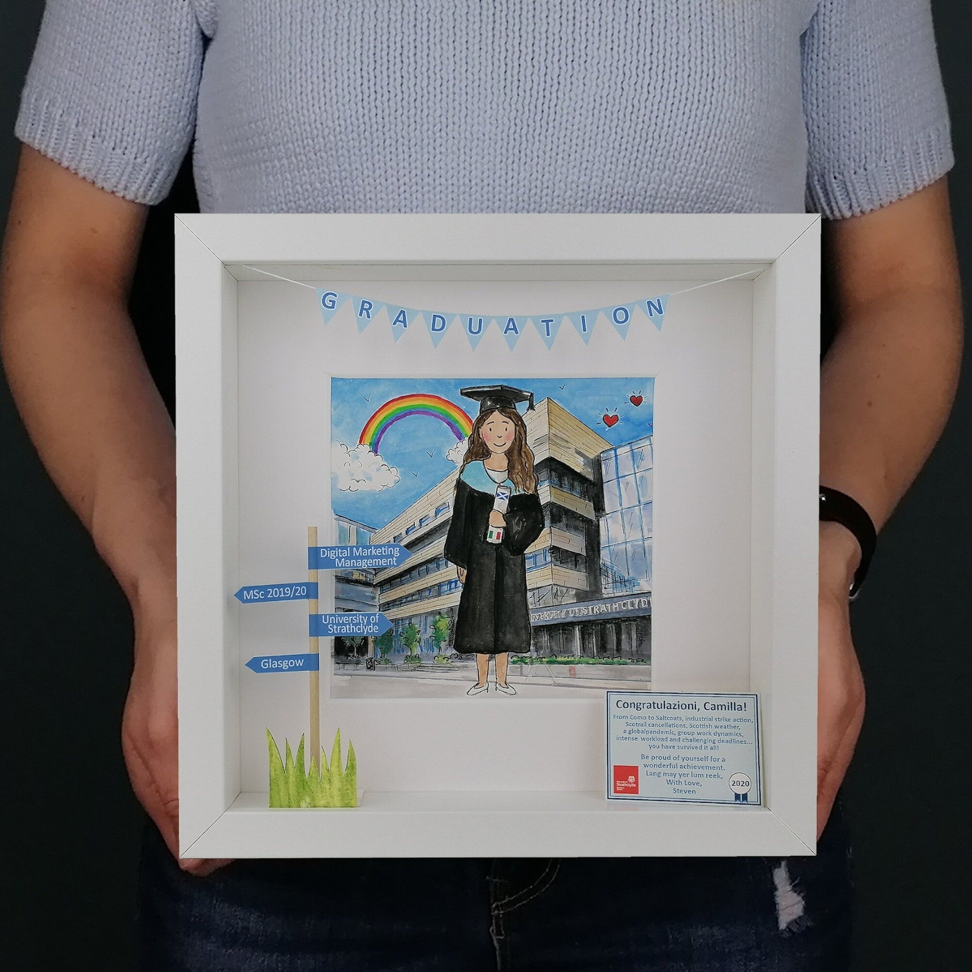 A custom illustration of a graduation girl in a blue graduation cap and gown, holding a diploma, with a white frame.
