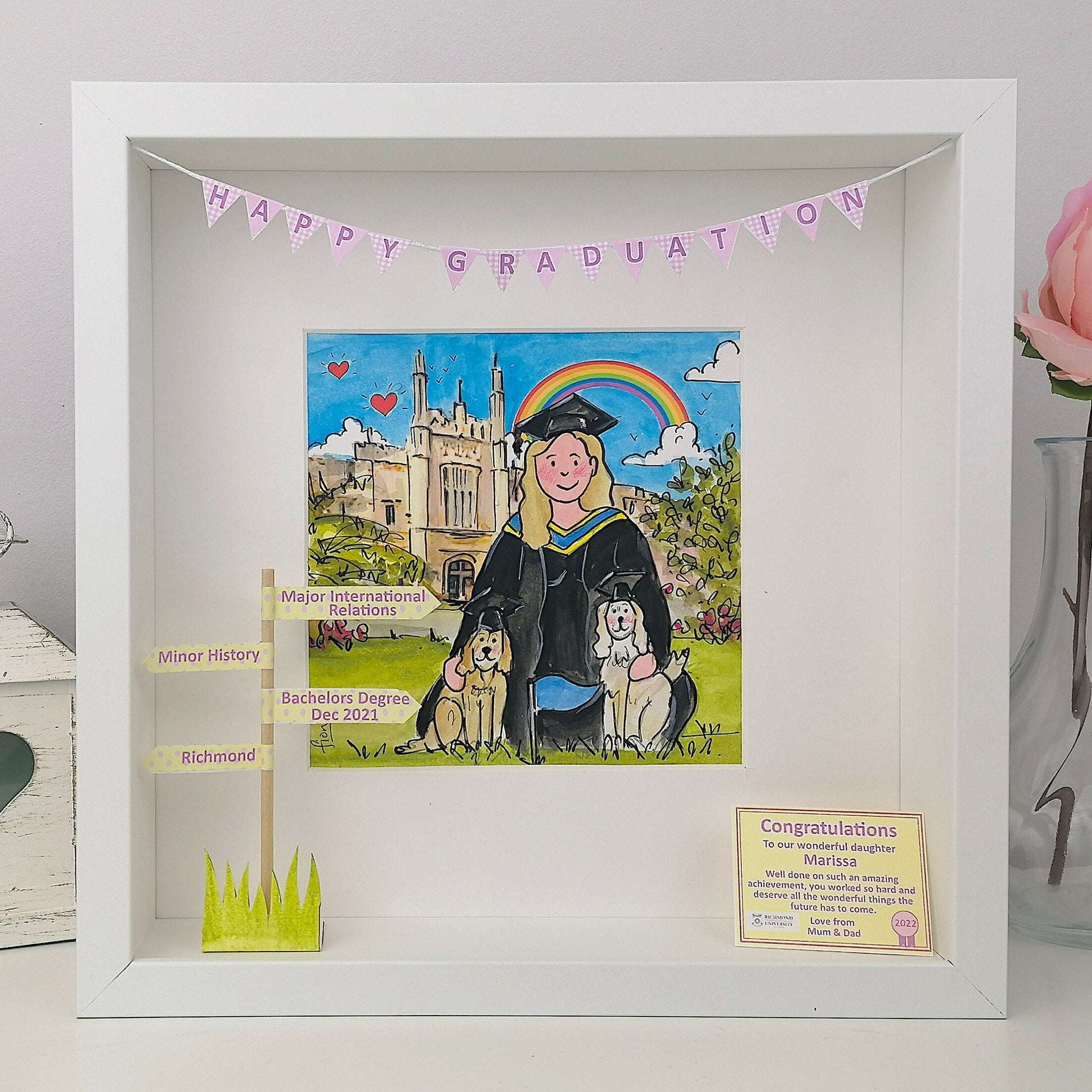 Box Frame illuDaughter Graduation Illustration in her gown with 2 dogs wearing caps and Uni in background