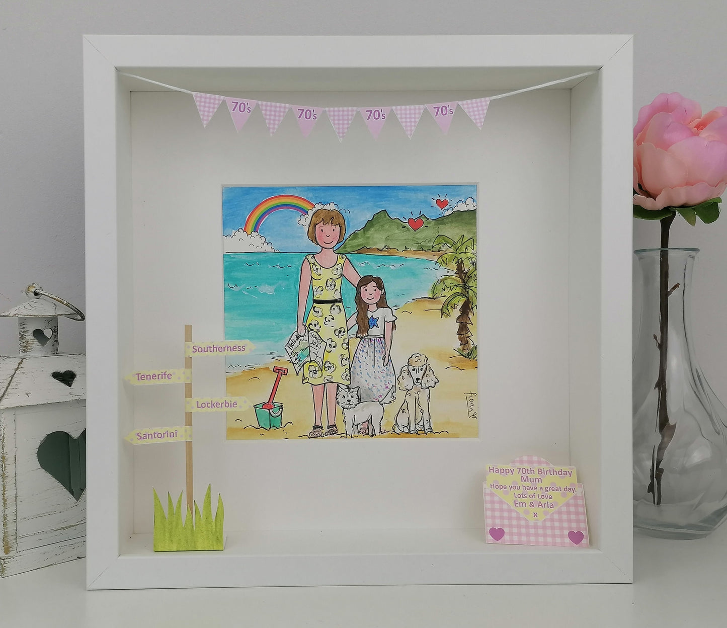 A custom illustration artwork in a frame, featuring a cartoon-style grandmother and granddaughter with a beach and palm trees in the background, accompanied by decorative bunting.
